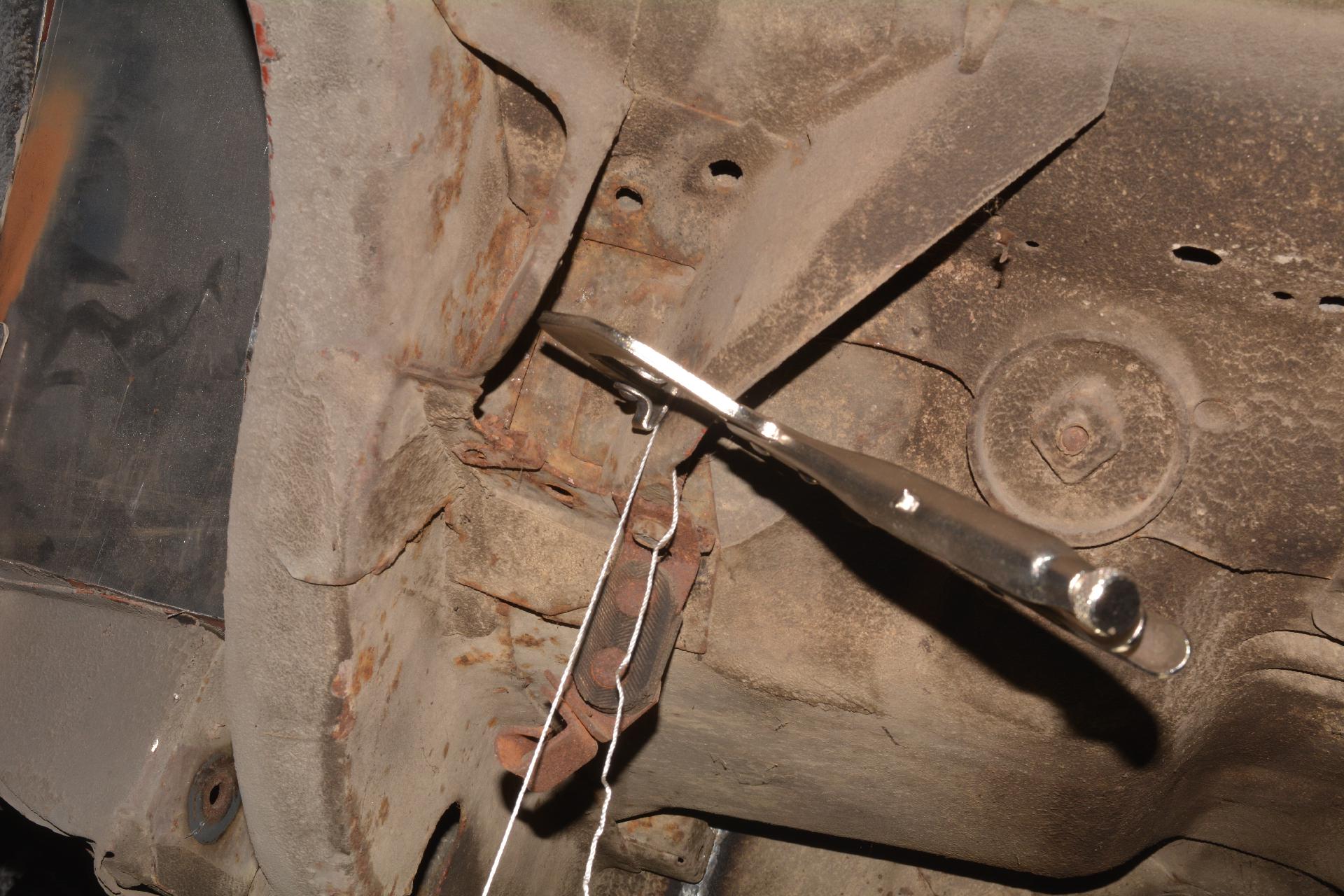 Attached plum bob in rear to upper control arm brackets